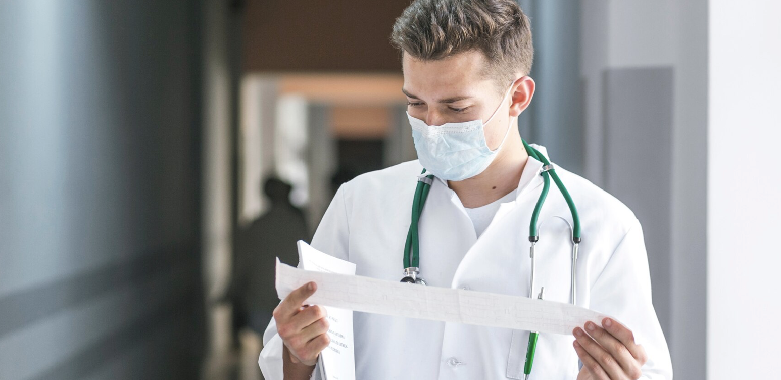 Doctor reading printout